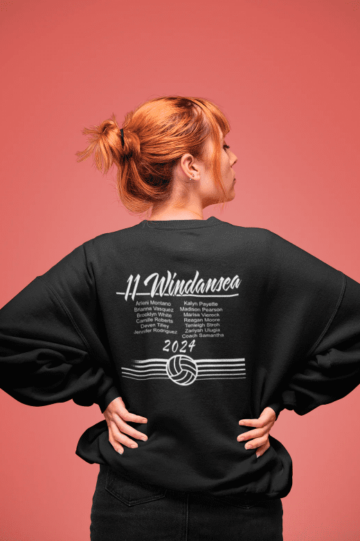 Example of 2024 Roster apparel. Girl with hands on hips in black crew neck sweatshirt with 11 Windansea roster on the back.
